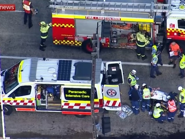 Emergency crews work to free a trapped motorist after a serious crash between a truck and a car shut down the Spit Bridge at Mosman. Picture: Sky News