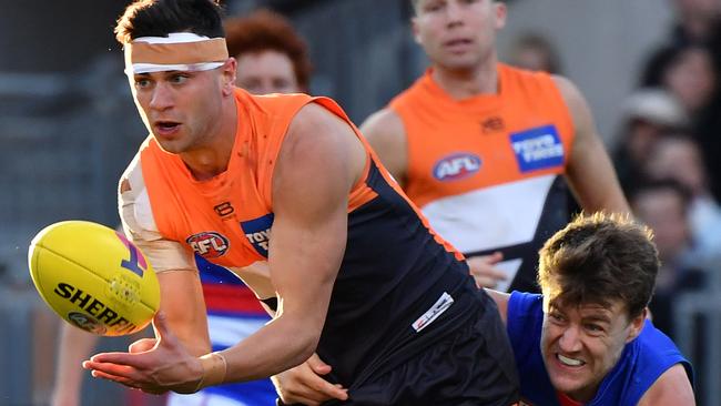 Tim Taranto of the Giants barges through a Josh Dunkley tackle.