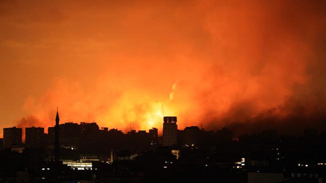 A ball of fire erupts in Gaza City after an Israeli air strike on October 12