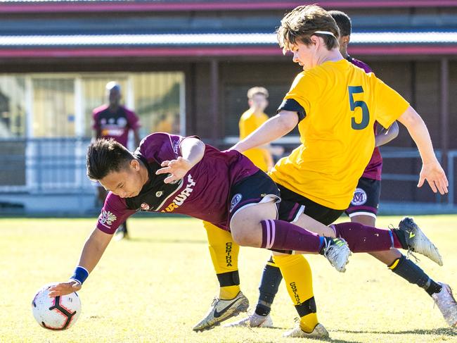 Chai Cheng is tackled in the Queensland Schools Premier League Football match between Marsden and Corinda at Darra, Thursday, July 30, 2020 - Picture: Richard Walker