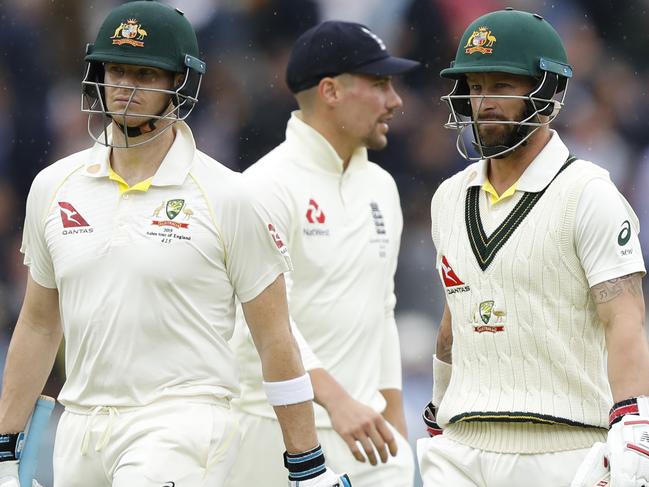 Australia's Steve Smith, left and teammate Australia's Matthew Wade walk off the pitch as rain stops play on day three of the 2nd Ashes Test cricket match between England and Australia at Lord's cricket ground in London, Friday, Aug. 16, 2019. (AP Photo/Alastair Grant)