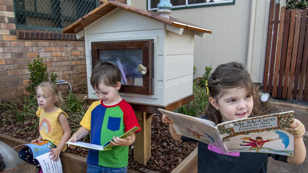 Kindy students (from left) Macie Crawford, Harrison Schmidt and Ruby Inglis enjoying the new books inside thier street library. Picture: Nev Madsen