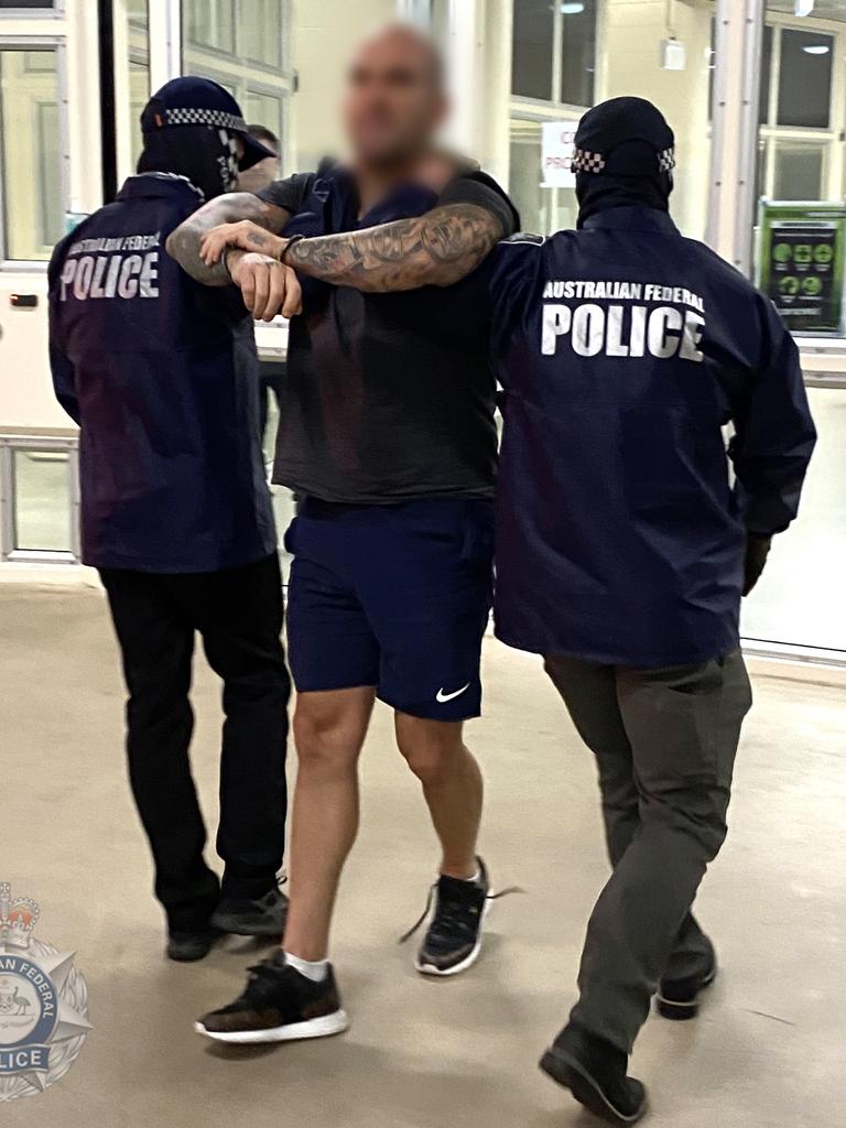 Australian Federal Police officers arrest Buddle. Pictures: Supplied