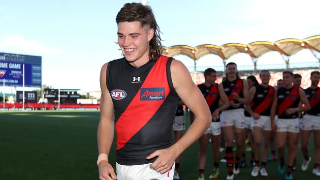 Sam Durham leads the Bombers off after the win over North Melbourne. Picture: Getty Images