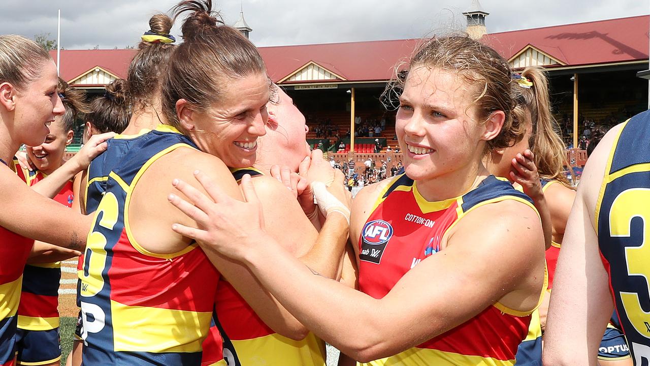 Chelsea Randall and Chloe Scheer celebrate the win and the top of the table finish after beating Collingwood. Picture: Sarah Reed/AFL Photos via Getty Images