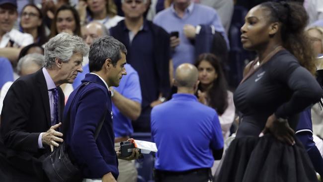 Carlos Ramos is escorted off the court at the completion of the women’s final.