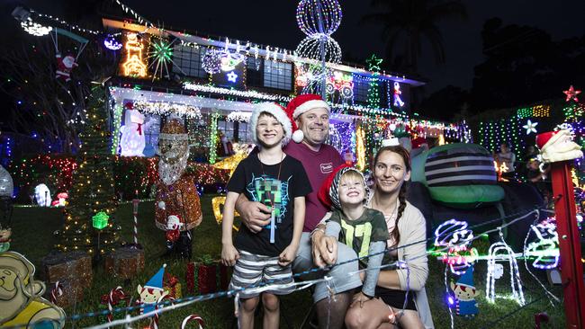 Trisha Chatman, her husband Jason and two children, Lachlan 4 and Jayden 6 years old outside their home decorated with Christmas lights in Borgnis St. Picture: John Feder/The Australian.