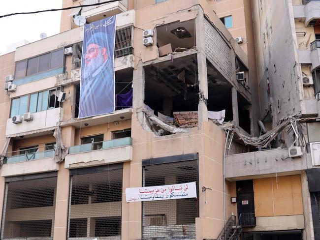 A banner depicting Hezbollah Secretary General Hassan Nasrallah on a building hit by a drone attack, killing Hamas number two in a southern Beirut stronghold of Hamas ally Hezbollah. Picture: AFP
