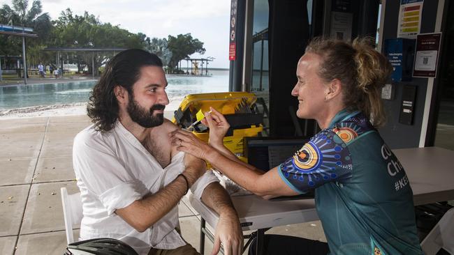 Cairns doctor Luke Ciantar receives his Covid-19 booster shot from public health nurse Lisa Mazlin at a pop-up vaccination clinic at the Esplanade Lagoon in Cairns. Picture: Brian Cassey