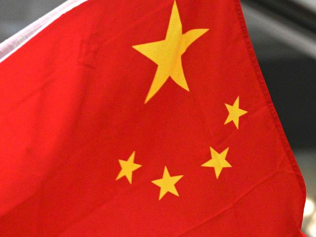 A woman sings and waves the national flag of China during a pro-Beijing flash mob at the Pacific Place shopping mall in Hong Kong on September 24, 2019. - Pro-democracy supporters have taken to Hong Kong's streets for almost four months in the biggest challenge to China's rule since the city's handover from Britain in 1997. Supporters of the local police and government, many waving Chinese flags, have organised rallies although they have been smaller than the huge pro-democracy marches. (Photo by Anthony WALLACE / AFP)