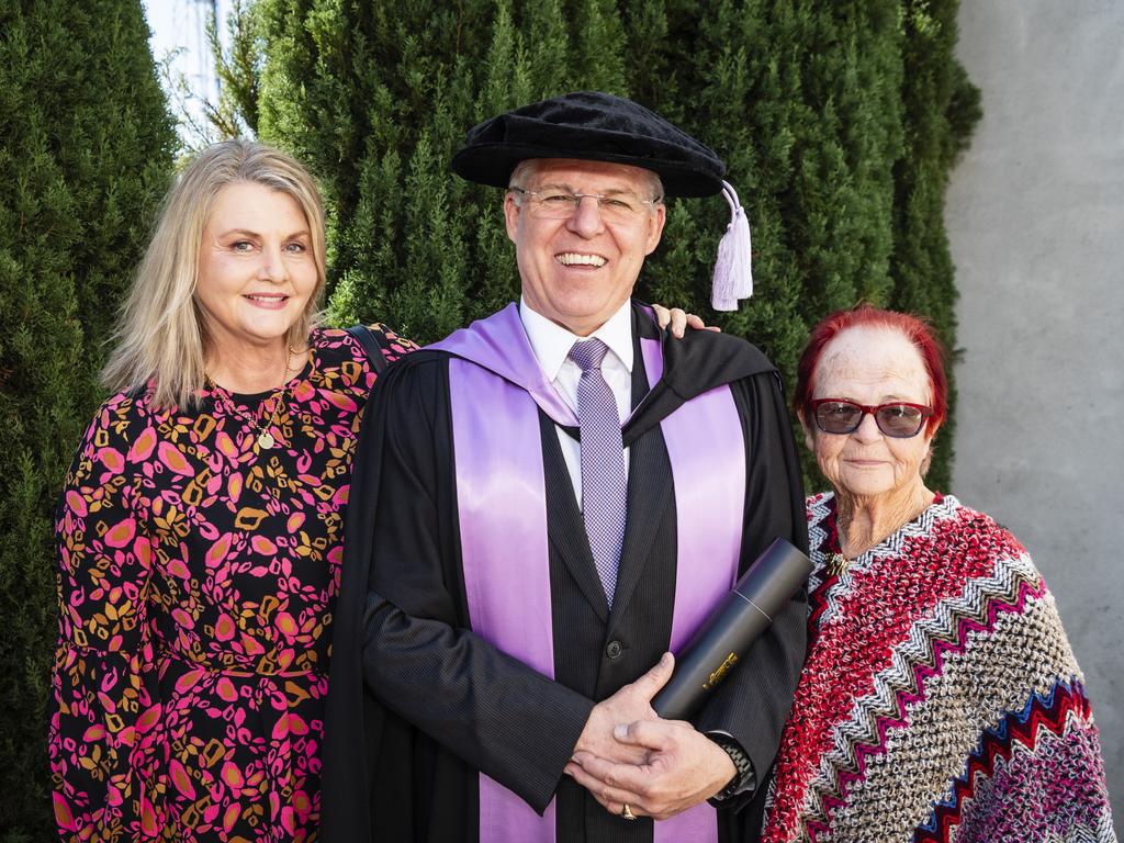 Doctor of Professional Studies graduate Troy Dux is congratulated by his wife Sharon Dux and mum Wendy Dux at the UniSQ graduation ceremony at Empire Theatres, Tuesday, June 27, 2023. Picture: Kevin Farmer