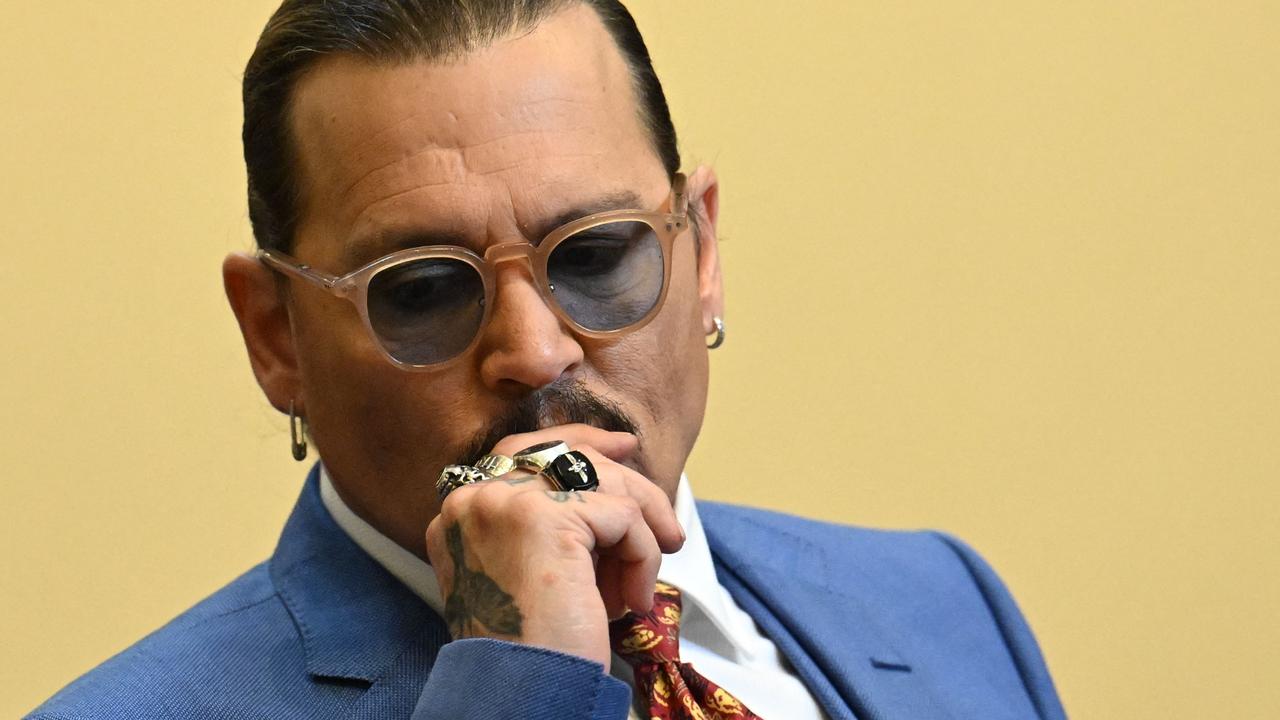 US actor Johnny Depp listens during the trial at the Fairfax County Circuit Courthouse in Fairfax, Virginia. (Photo by JIM WATSON / POOL / AFP)