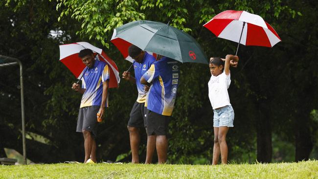 With Tropical Cyclone Megan threatening the Northern Territory and Queensland border, wet weather is forecast for Cairns this week. Spectators shelter from the heavy rain under umbrellas as they watch the A Grade match between the Cairns Kangaroos and the Innisfail Brothers at Vico Oval, Mooroobool. Picture: Brendan Radke