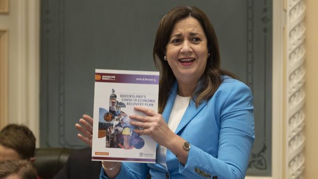 Queensland Premier Annastacia Palaszczuk holds up her Covid-19 economic recovery plan during question time. Picture: Sarah Marshall