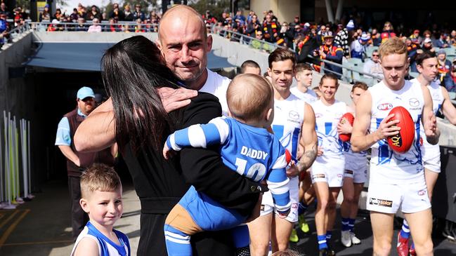 ADELAIDE, AUSTRALIA - AUGUST 13: Ben Cunnington of the Kangaroos walks out with his family during the 2022 AFL Round 22 match between the Adelaide Crows and the North Melbourne Kangaroos at Adelaide Oval on August 13, 2022 in Adelaide, Australia. (Photo by James Elsby/AFL Photos via Getty Images)