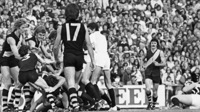 Port star Brian Cunningham, top right, is down and his adversary, Wayne Phillis, has disappeared under a pile of players after the clash sparked a melee involving 28 players at Football Park in 1976.