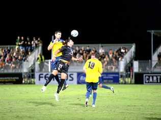 NPL THRILLER: South West Queensland Thunder's Keagan Sheridan (left) contests a high ball with Magpies Crusaders striker Kyle Markham. The Thunder won the NPL clash 4-3 after trailing 2-0 at halftime. Picture: Daniel McKenzie