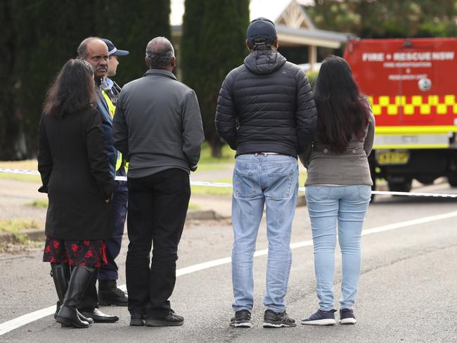 Neighbours watched on at the scene. Picture: John Grainger