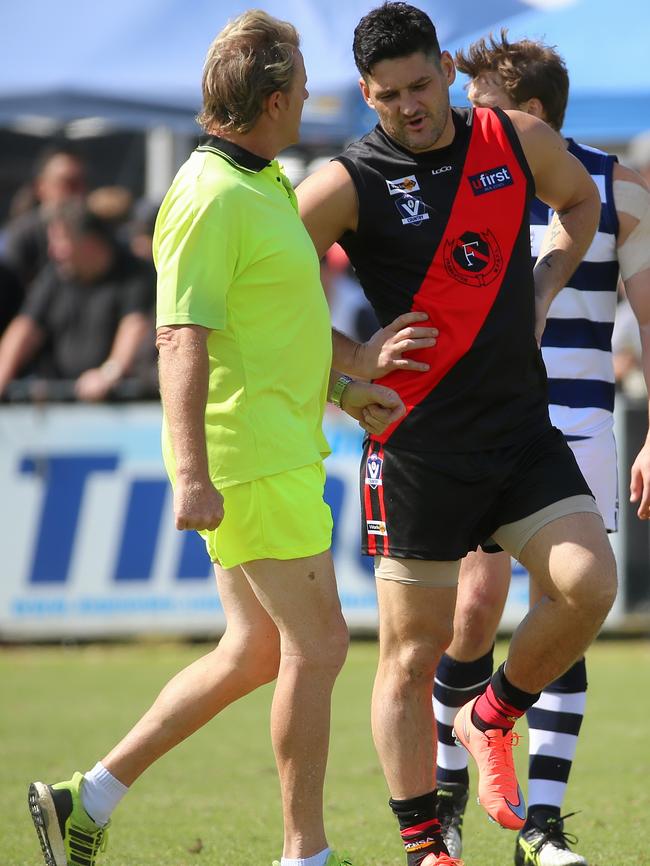 Frankston runner Dermott Brereton speaks with Brendan Fevola during the Bombers’ Good Friday Nepean League win over Pearcedale. Picture: Hamish Blair