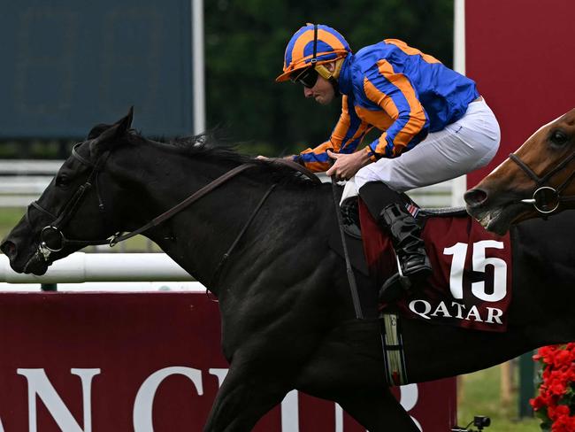RL Moore riding Camille Pissaro crosses the finish to win the 185th Qatar Prix du Jockey Club horse race at the Chantilly race course, north of Paris on June 1, 2025. (Photo by Hugo MATHY / AFP)