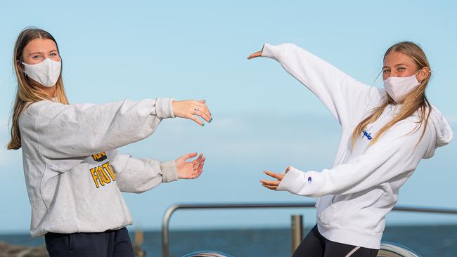 Best friends Zarah Coxhell, 17, and Winnie Laing, 18, have adapted their greetings. Picture: Jason Edwards