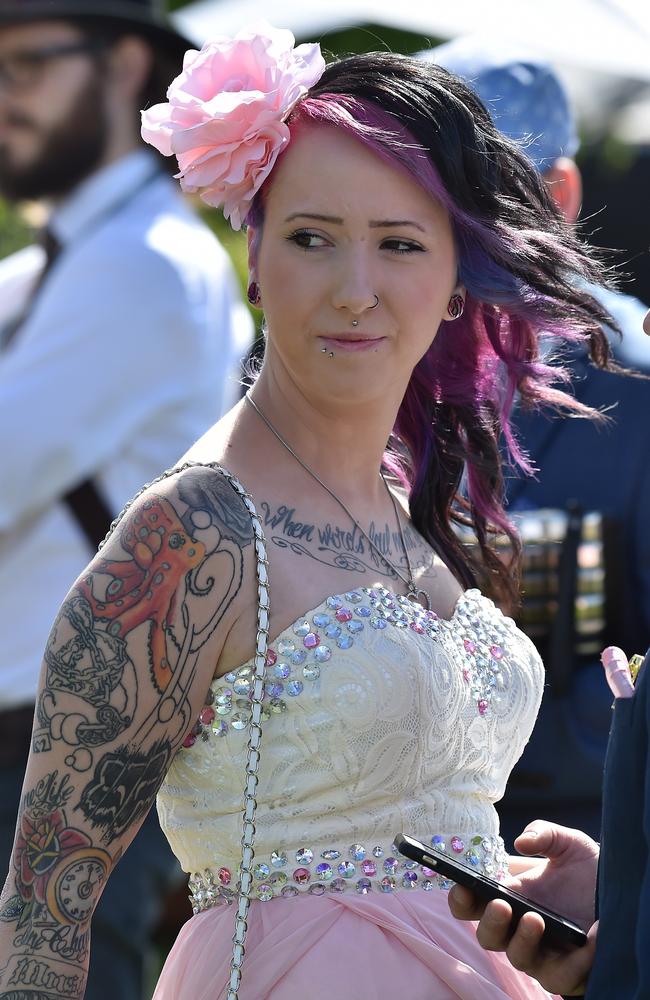 A racegoer prepares for the annual Fashion on the Field competition at Flemington Racecourse on Melbourne Cup day in Melbourne on November 3, 2015. Picture: AFP PHOTO/Paul CROCK