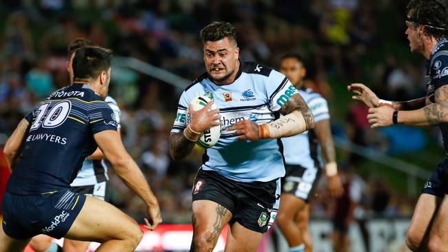 Sharks Andrew Fifita looks for a gap between Cowboys defenders James Tamou, left, and Ethan Lowe during their round 1 NRL match between the North Queensland Cowboys and the Cronulla Sharks at 1300 Smiles Stadium in Townsville, Saturday, March 5, 2016. (AAP Image/Michael Chambers) NO ARCHIVING, EDITORIAL USE ONLY