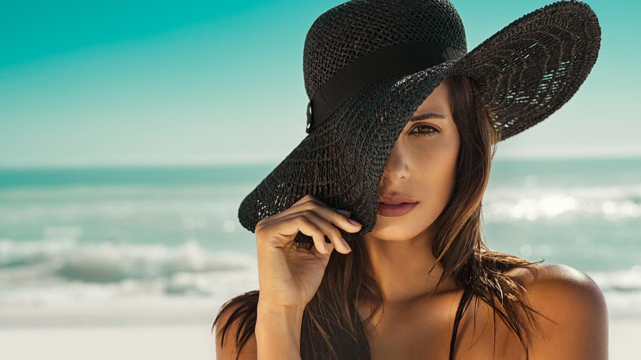 Fashion woman with straw hat at beach