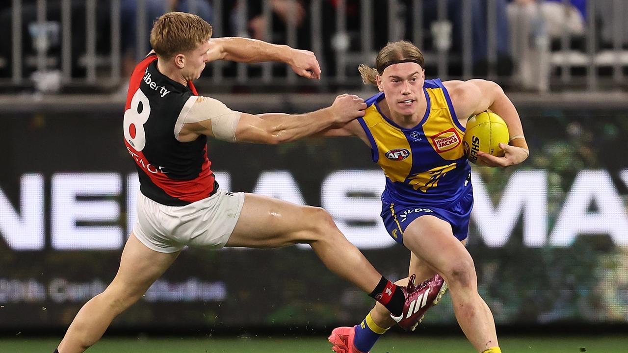 Harley Reid of the Eagles fends off Ben Hobbs of the Bombers during the round eight AFL match between West Coast Eagles and Essendon Bombers at Optus Stadium, on May 04, 2024, in Perth, Australia. (Photo by Paul Kane/Getty Images)