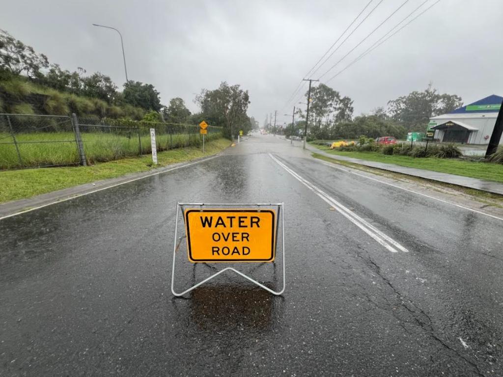 Car abandoned in floodwater at Siganto Drive in Helensvale