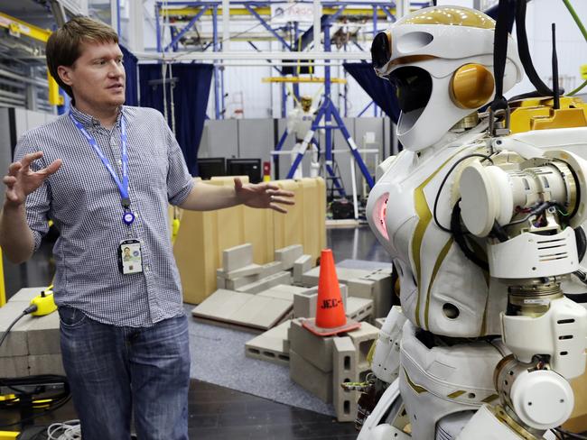 Andrew Watson, a software developer for the Valkyrie 8 project, with the Valkyrie humanoid robot. Picture: Michael Wyke