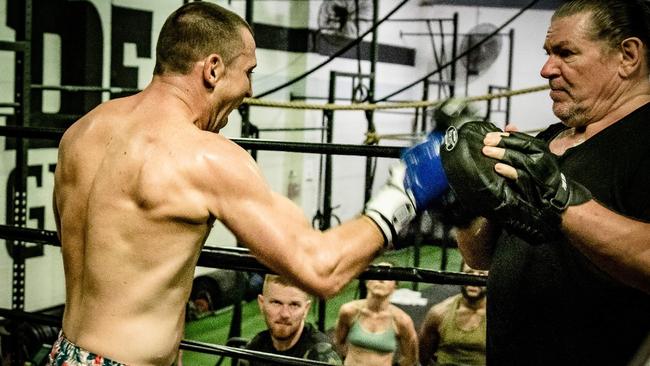 Ben O'Connor training at DF Gym with coach Jimmy Richards while friend Thomas McRoberts watches on. Picture: Supplied