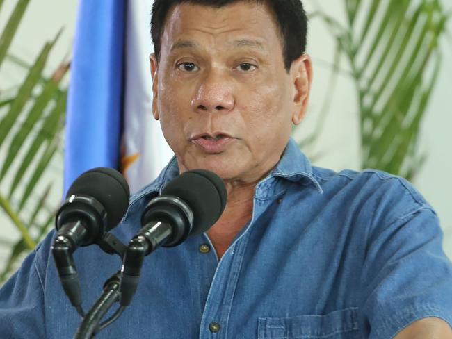 (FILES) This file photo taken on October 16, 2016 shows Philippine President Rodrigo Duterte as he gestures delivering his speech prior to departing for a visit to Brunei and China at Davao airport. The government of Philippines President Rodrigo Duterte has made no formal request to modify its cooperation with Washington, despite his declared 