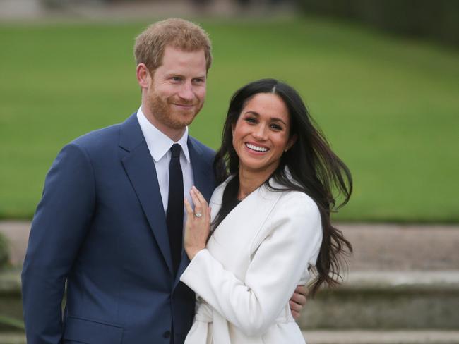 (FILES) In this file photo taken on November 27, 2017 Britain's Prince Harry and his fiancÃ©e US actress Meghan Markle pose for a photograph in the Sunken Garden at Kensington Palace in west London on November 27, 2017, following the announcement of their engagement. - Meghan Markle has revealed she suffered a miscarriage in July this year, writing in the New York Times on November 25, 2020 of the deep grief and loss she endured with her husband Prince Harry. (Photo by Daniel LEAL-OLIVAS / AFP)