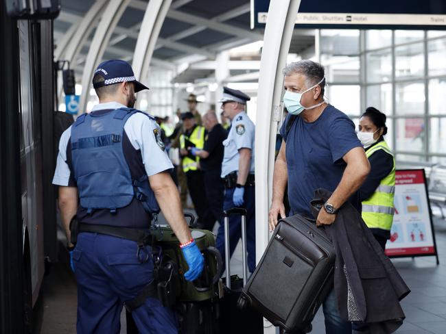 Passengers are placed on buses and ferried to hotels at Sydney International Airport after the government announced anyone entering Australia must quarantine in hotels for 14 days. Picture: Nikki Short