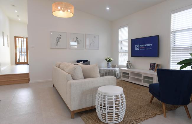 A high raked ceiling and sunken floor in the rear living area creates a beautiful space, which is enhanced by natural light.