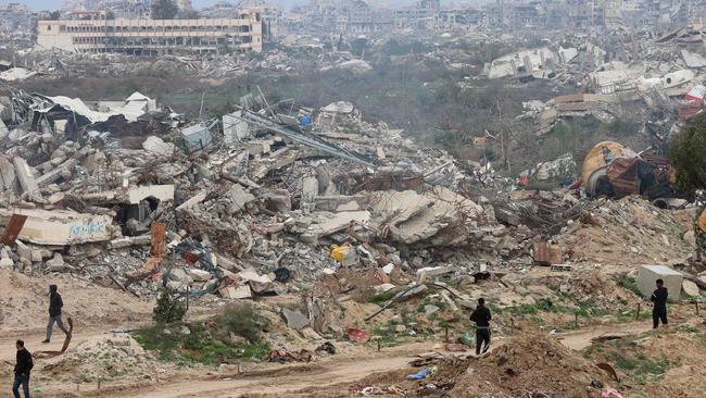 Displaced Palestinians cross the Netzarim corridor as they make their way to the northern parts of the Gaza Strip after the Israeli military withdrew. Picture: AFP.