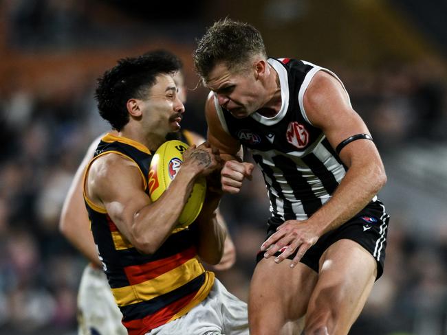 ADELAIDE, AUSTRALIA - AUGUST 17:   Izak Rankine of the Crows is knocked out by  a late hit from  Dan Houston of the Power during the round 23 AFL match between Port Adelaide Power and Adelaide Crows at Adelaide Oval, on August 17, 2024, in Adelaide, Australia. (Photo by Mark Brake/Getty Images)