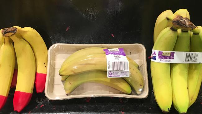 Woolworths’ non-organic bananas (L) were not packaged. Its organic bananas had two different packages — a cardboard tray and film or a plastic band (R).