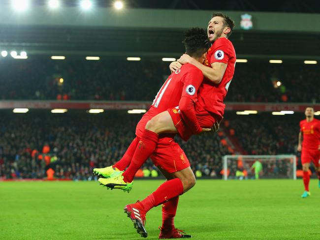 Firmino celebrates with Adam Lallana after scoring.