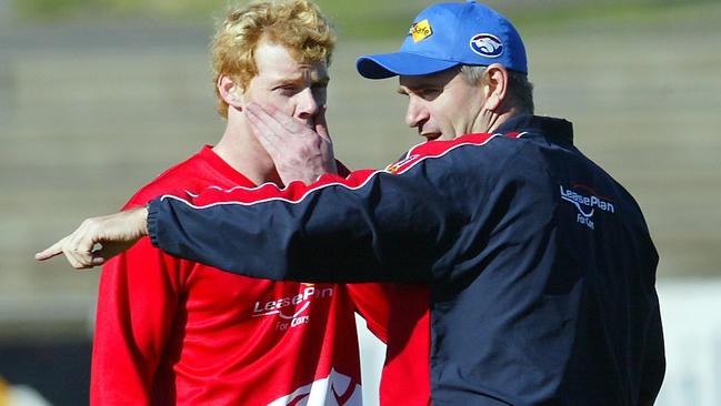 Adam Cooney talks to Peter Rohde during training in 2004.