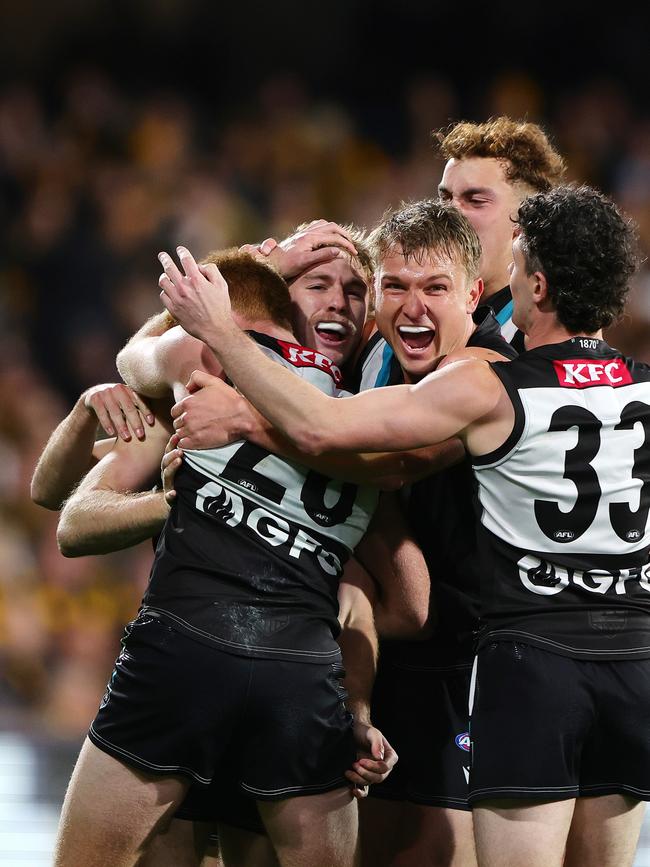 Jason Horne-Francis of the Power celebrates a goal with teammates. Picture: Sarah Reed/AFL Photos via Getty Images)