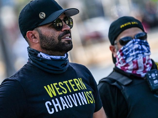 (FILES) Leader of the Proud Boys Enrique Tarrio (L), wearing a shirt supporting Derek Chauvin, joins a counter-protest where people gathered to remember George Floyd on the one-year anniversary of his death at the hands of Minneapolis police officer, including Chauvin, in Miami on May 25, 2021. Enrique Tarrio, the former leader of the far-right Proud Boys militia, was sentenced to 22 years in prison on September 5, 2023, the stiffest sentence handed out so far for the 2021 attack on the US Capitol. "That day broke our previously unbroken tradition of peacefully transferring power," US District Judge Timothy Kelly said. (Photo by CHANDAN KHANNA / AFP)