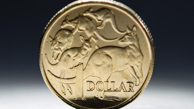 An Australian one-dollar coin is arranged for a photograph in Sydney, Australia, on Wednesday, April 17, 2013. Direct trading between the Australian dollar and yuan started on April 10. Photographer: Ian Waldie/Bloomberg