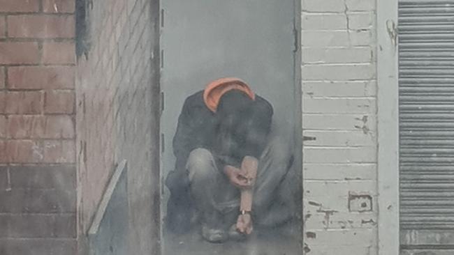 A man injecting himself in the Boyd Lane alleyway way in Dandenong.