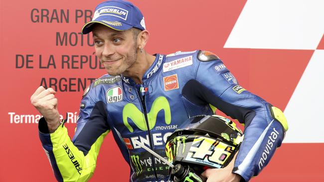 FILE -- In this April, 9, 2017 file photo, Italy's Valentino Rossi celebrates winning second place at the end of the MotoGP race of Argentina's Motorcycle Grand Prix at the Termas de Rio Hondo circuit in Argentina. Six-time MotoGP champion Rossi has reportedly broken his right leg in a training accident in Italy. According to Italian sports daily Gazzetta dello Sport, Rossi fell during enduro training and fractured his tibia and fibula. (AP Photo/Nicolas Aguilera)