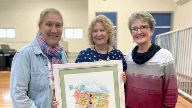 Gillwinga Public School teacher Maree Davis (centre) is presented with her retirement gift by former colleagues Debbie Brookes and Shauna Baker.