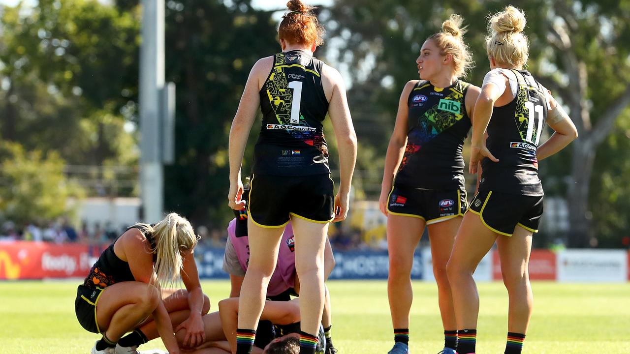 MELBOURNE, AUSTRALIA - JANUARY 22: Harriet Cordner of the Tigers receives medical attention after a collision during the round three AFLW match between the Richmond Tigers and the Fremantle Dockers at Punt Road Oval on January 22, 2022 in Melbourne, Australia. (Photo by Kelly Defina/Getty Images)