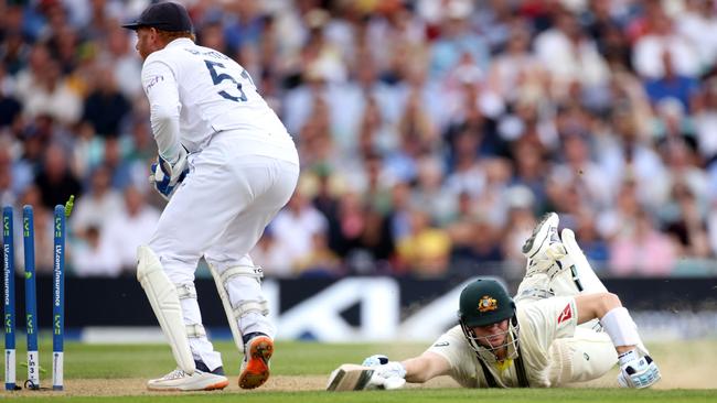 Steve Smith makes his ground as Jonny Bairstow knocks the bails off with his glove. Picture: Getty Images