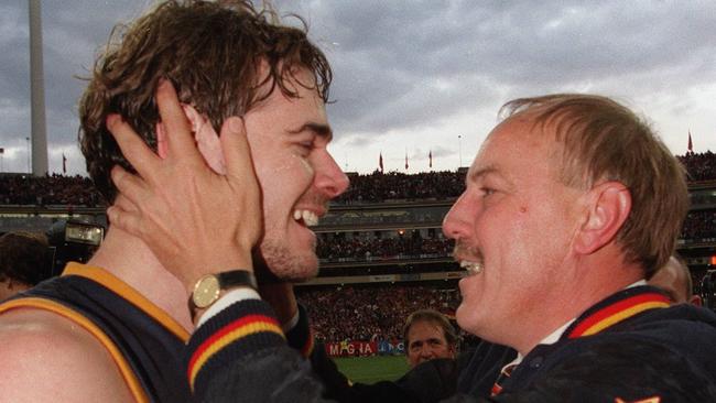 All is forgiven ... David Pittman is congratulated by Malcolm Blight after the Crows’ 1997 Grand Final win. It had been a very different story early in the season. Picture: Michael Dodge